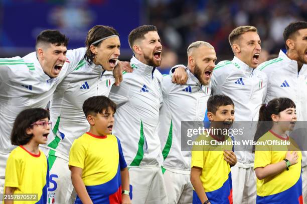 The mascots join in as the Italy team enthusiastically sing their national anthem during the UEFA EURO 2024 group stage match between Spain and Italy...
