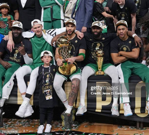 Neemias Queta, Kristaps Porzingis, Deuce Tatum, Jayson Tatum, Jaylen Brown and Jaden Springer of the Boston Celtics celebrate with the Larry O'Brien...