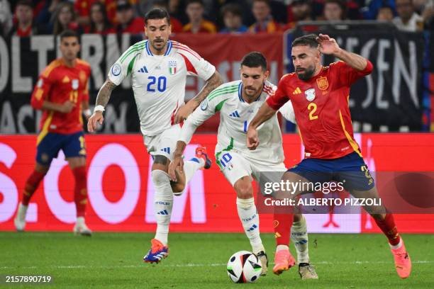 Spain's defender Dani Carvajal fights for the ball with Italy's midfielder Lorenzo Pellegrini during the UEFA Euro 2024 Group B football match...