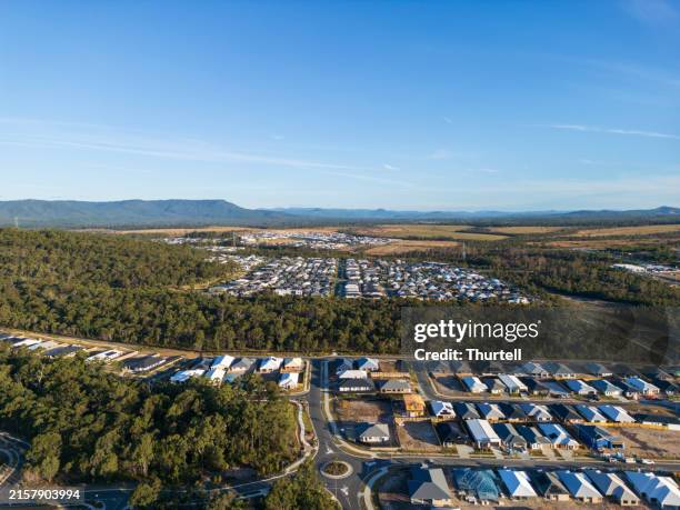 drone view of new housing development - wohnungsprobleme stock-fotos und bilder