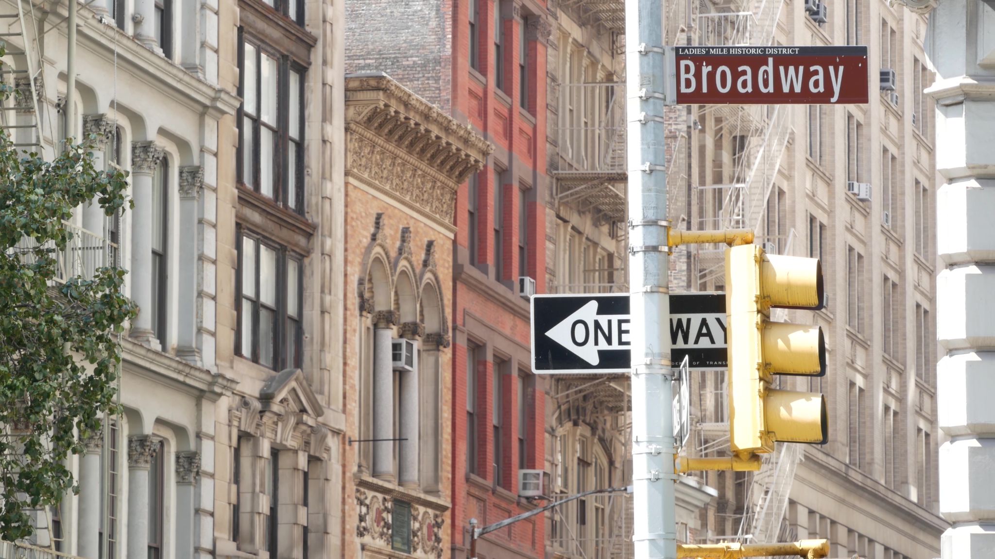 Broadway street road sign, Manhattan midtown architecture, New York City real estate. One way traffic Broadway street road sign, Manhattan midtown architecture, New York City real estate. One way traffic