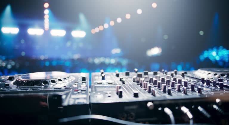 https://media.gettyimages.com/id/2157936507/video/establishing-footage-with-professional-dj-equipment-on-a-club-stage-mixing-decks-controllers.jpg?b=1&s=640x640&k=20&c=ee2f-O-49H6qiBF9sEZhE6wKeONfZpFrnO7sc5a9As8=
