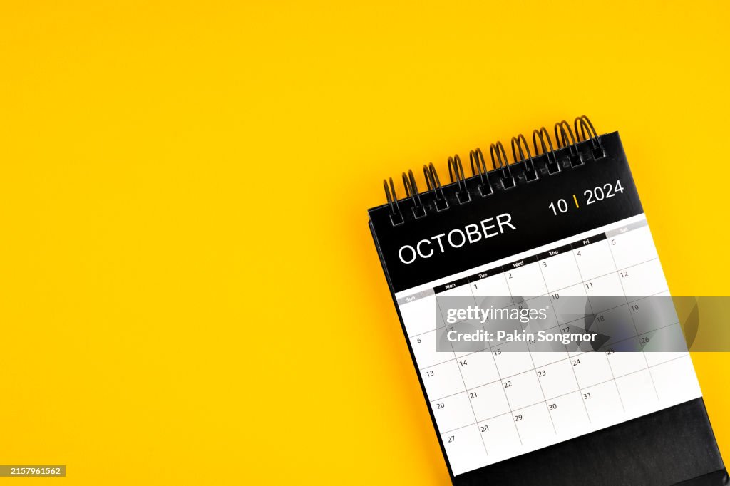 October 2024 Desk Calendar on yellow color background, Position with copy space.
