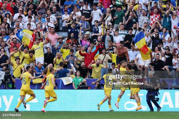 Denis Dragus of Romania celebrates scoring his team's third goal with teammates during the UEFA EURO 2024 group stage match between Romania and...