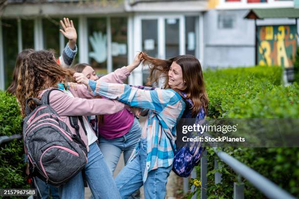 the girls are in front of the school - friendly rivalry stock pictures, royalty-free photos & images