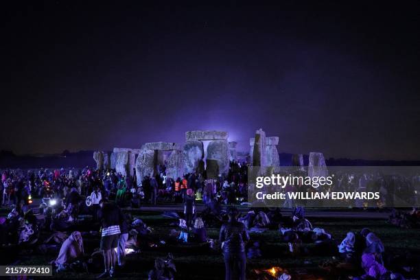 Revellers gather to wait for the sun to rise at Stonehenge, near Amesbury, in Wiltshire, southern England on June 21 during the Summer Solstice...