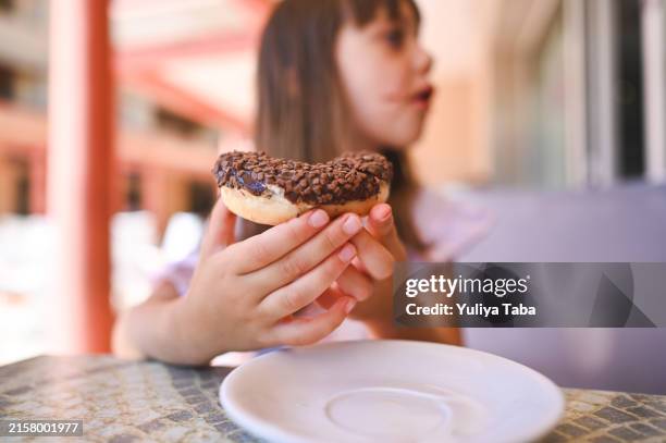 close up of chocolate doughnuts. - chocolate doughnut stock pictures, royalty-free photos & images