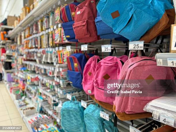 school backpacks at stationery shop - back to school stock pictures, royalty-free photos & images