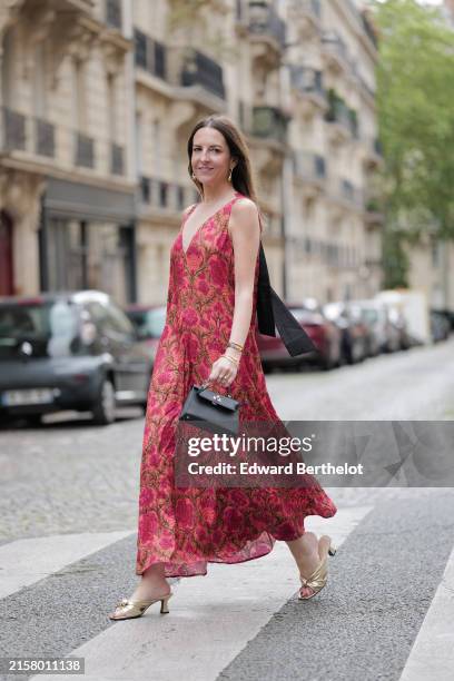 Alba Garavito Torre wears a red Flower print long dress with a tulle collar and black cotton tarsier bow on the neck from Frambua, gold kitten heel...