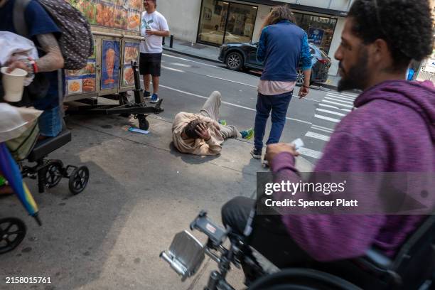 Individuals, many with drug dependency issues, gather near the Port Authority Bus Terminal on June 17, 2024 in New York City. The area has become a...