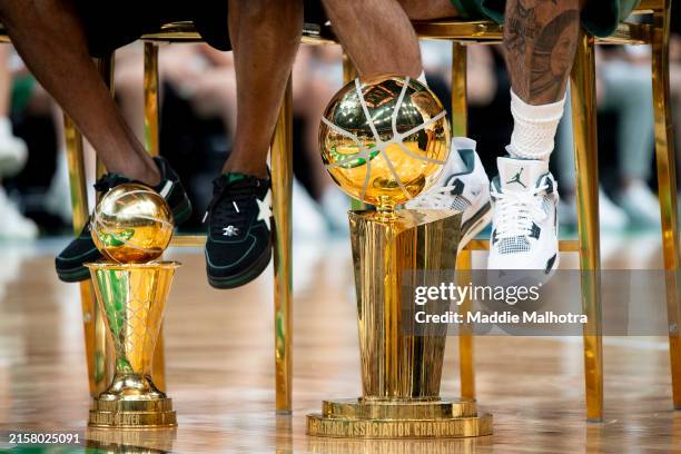 Jaylen Brown of the Boston Celtics and Jayson Tatum of the Boston Celtics sit with the MVP and Larry O'Brien trophies during the Boston Celtics...