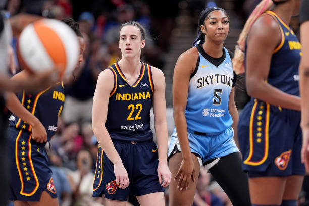 Caitlin Clark of the Indiana Fever and Angel Reese of the Chicago Sky look on during a game at Gainbridge Fieldhouse on June 16, 2024 in...