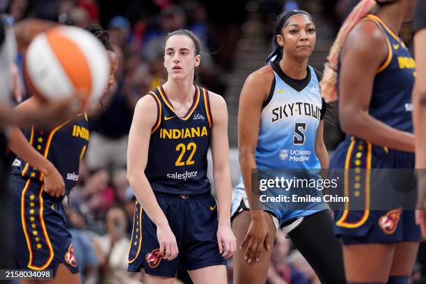 Caitlin Clark of the Indiana Fever and Angel Reese of the Chicago Sky look on during a game at Gainbridge Fieldhouse on June 16, 2024 in...