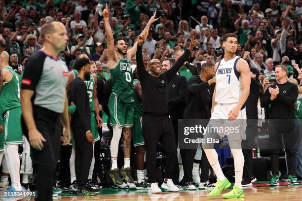 Jayson Tatum of the Boston Celtics celebrates while Dwight Powell of the Dallas Mavericks looks on during the closing seconds of the fourth quarter...