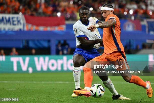France's defender Dayot Upamecano and Netherlands' forward Memphis Depay fight for the ball during the UEFA Euro 2024 Group D football match between...