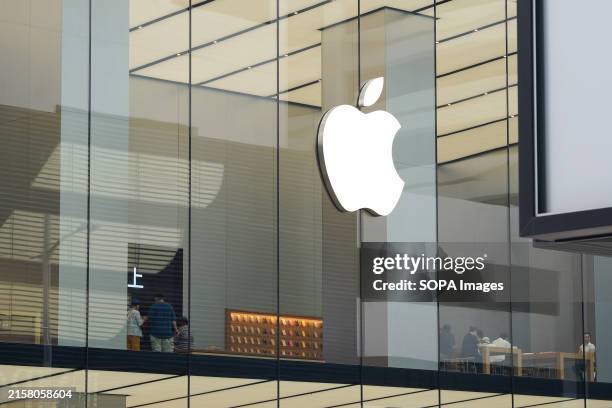 American multinational technology company, The Apple logo is above at an Apple retail store in Hong Kong.