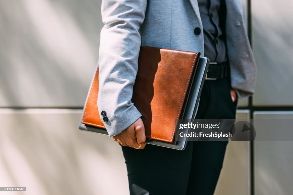 Business Person Holding Leather Portfolio in Modern Attire