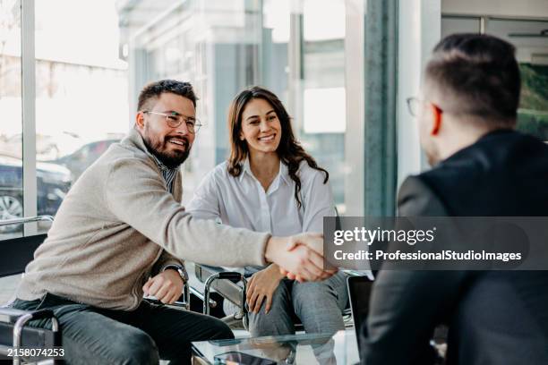 a collective handshake of satisfaction - car sales team stock pictures, royalty-free photos & images