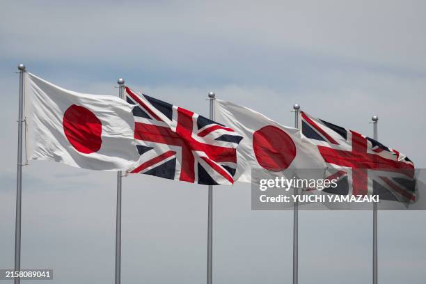 National flags of Japan and Britain flutter at Haneda airport before Emperor and Empress' departure for Britain in Tokyo on June 22, 2024.
