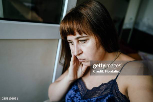 a middle-aged woman at home - dizzy birds stock pictures, royalty-free photos & images