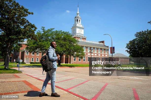 Graduate student Eduardo Miranda waits for a ride while standing near the The Morris Family Center for Law & Liberty building on the campus of...