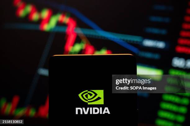 In this photo illustration, the American graphics processing technology and semiconductors company Nvidia logo seen displayed on a smartphone with a...