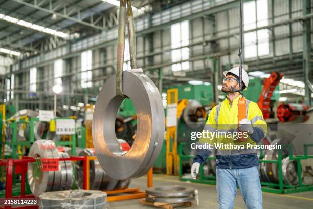 using a remote control in order to operate a crane, an engineer holds and works with it - picking up stock pictures, royalty-free photos & images