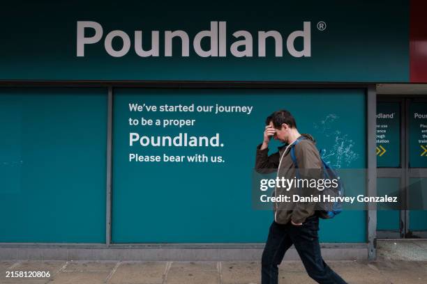 Member of the public passes down the signage of a temporarily closed branch of high street retailer Poundland as the UK's Labour Party announce their...