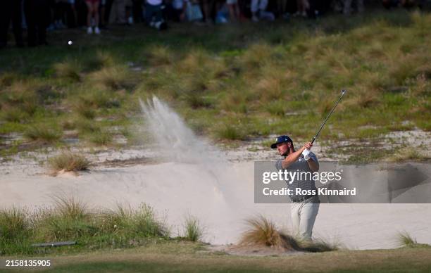 Bryson DeChambeau of the United States plays his third shot out of a greenside bunker on the 18th hole during the final round of the 124th U.S. Open...