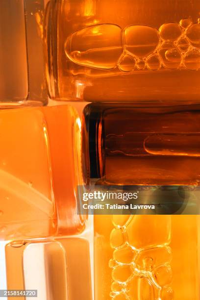 set of different cosmetic bottles lying next to each other and cropped by the frame. abstract background for beauty and fashion industry. skincare, wellness, spa - massageöl stock-fotos und bilder
