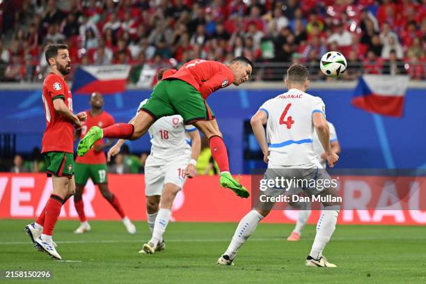 Cristiano Ronaldo of Portugal competes for a header whilst under pressure from Robin Hranac of Czechia during the UEFA EURO 2024 group stage match...