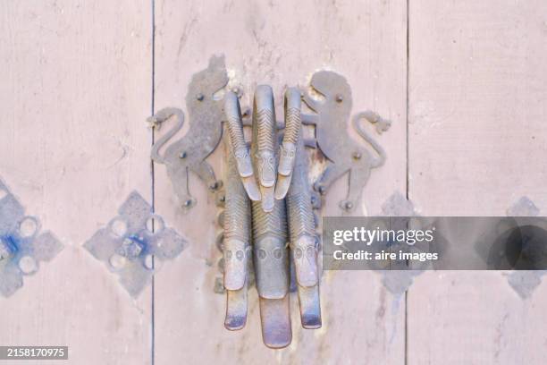 ornate metal door handle with lions - unusual buildings stock pictures, royalty-free photos & images