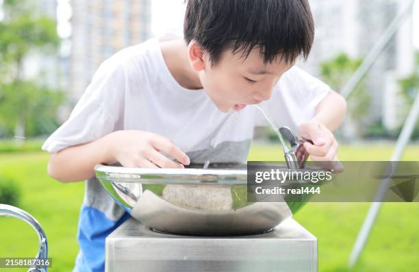 little boy drinking tap water - fountain stock pictures, royalty-free photos & images