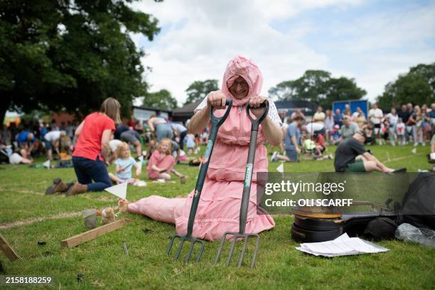 Chris White, dressed as a worm, competes in the annual World Worm Charming Championships held at Willaston Primary Academy in Willaston, near...
