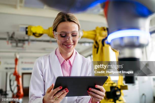 female robotic engineer working on robotic knee replacement surgery project, checking data in tablet. concept of robotics, engineering and computer science in healthcare. - network operations stock pictures, royalty-free photos & images