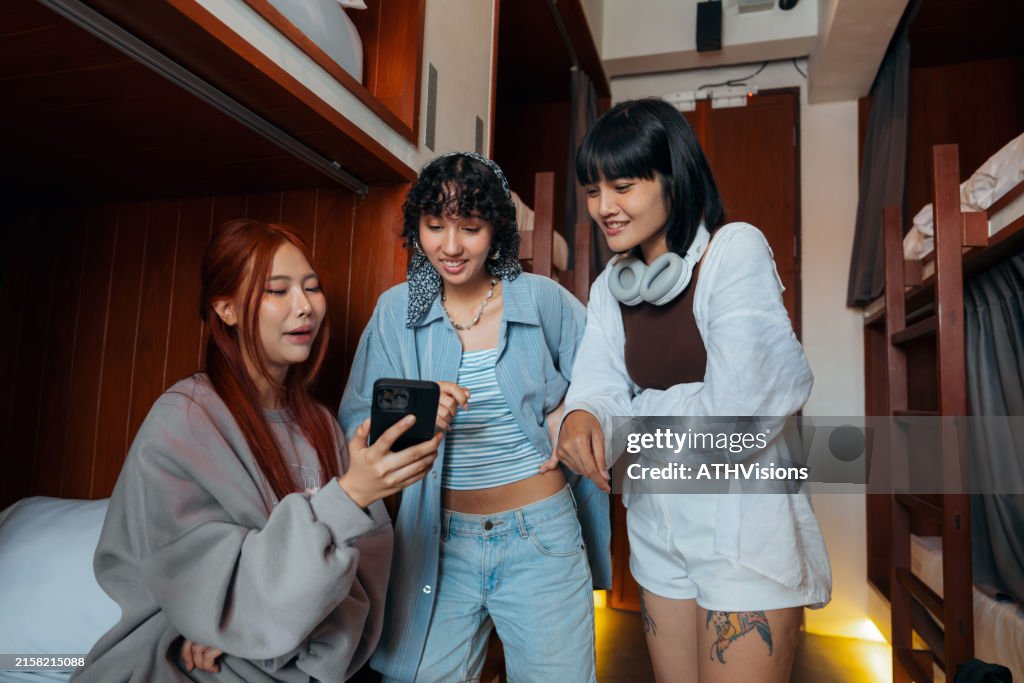 Friends Using Mobile app Smartphone searching food in Hostel Dormitory