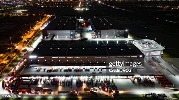Aerial view of express logistics vehicles loading and unloading express parcels at JD Logistics Kunshan Asia No.1 Intelligent Logistics Park during...