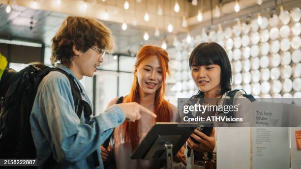 friends using self check-in on tablet at hostel - self service check in stock pictures, royalty-free photos & images