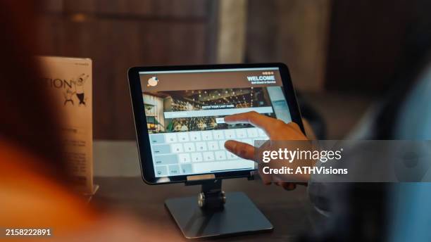 friends using self check-in on tablet at hostel - recepção de hotel imagens e fotografias de stock