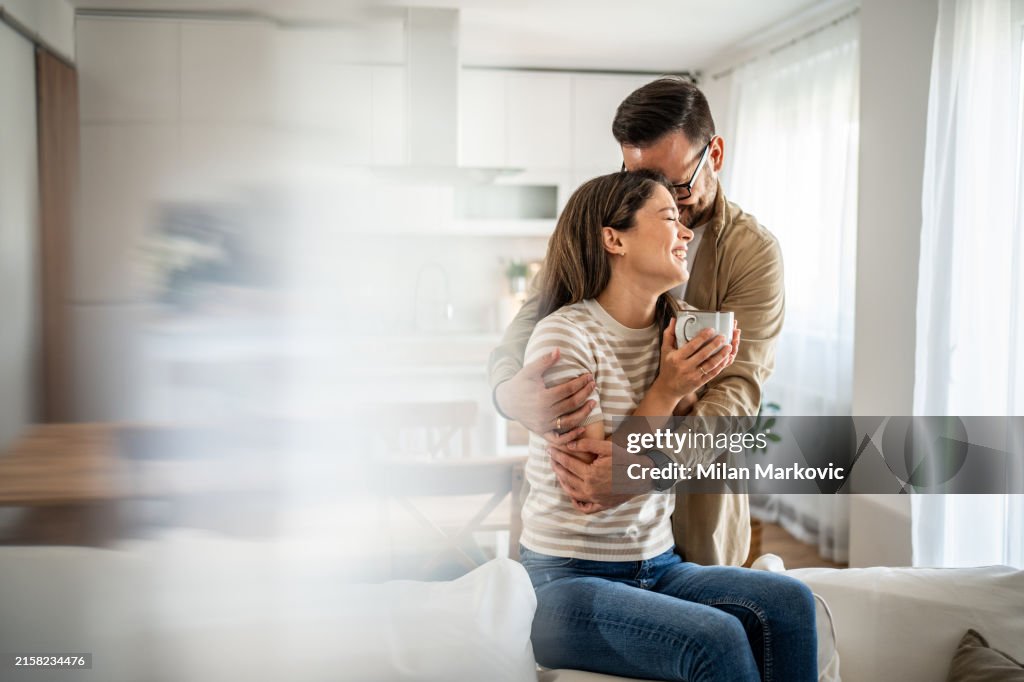 Young couple enjoying coffee in their new home