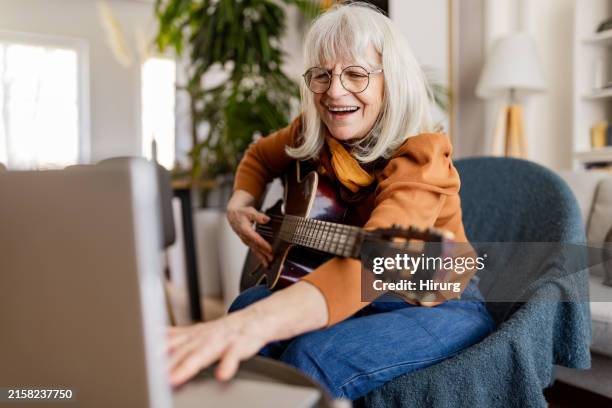 senior woman's acoustic guitar session - musikinstrument bildbanksfoton och bilder