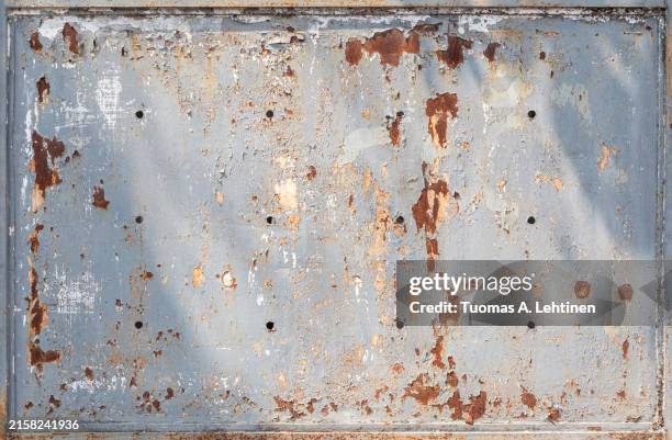 front view of a weathered, aged and dirty metal plate painted in light gray. - rusty stock pictures, royalty-free photos & images