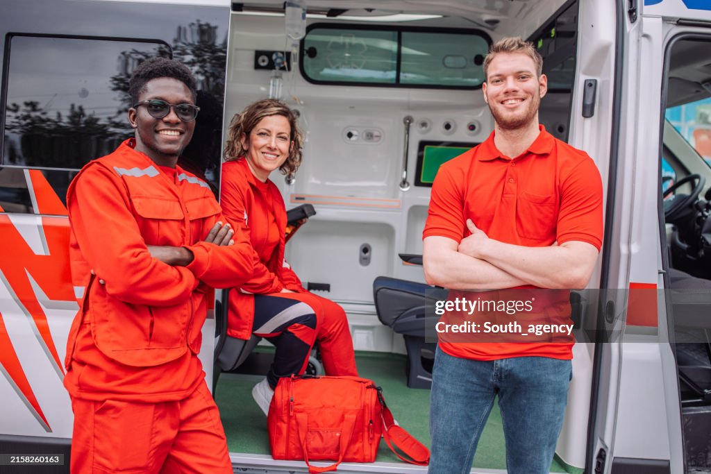 Smiling paramedics team with medical equipment
