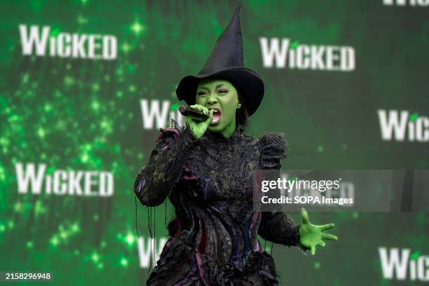 Alexia Khadime as Elphaba from musical Wicked seen singing on stage in full costume at West End Live. Musical Theatre shows from the West End and...
