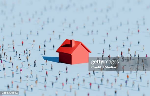 oversized housing symbol surrounded by people - woning huren stockfoto's en -beelden