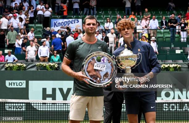 Winner Italy's Jannik Sinner and second placed Poland's Hubert Hurkacz pose with their trophies after the men's singles final tennis match of the ATP...