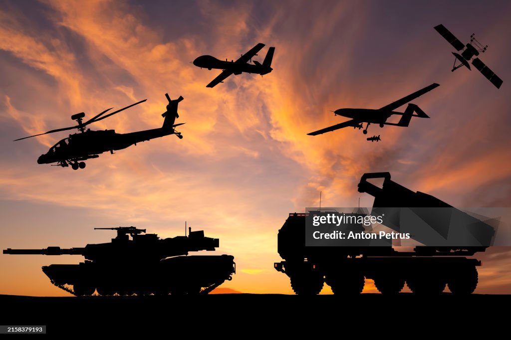 Armored tanks, combat drone and missile launcher at sunset. Modern US military equipment
