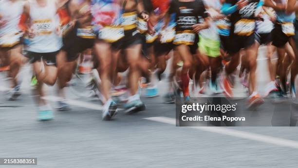 large group of unknown people running marathon, blurred motion - marathon stock pictures, royalty-free photos & images