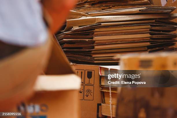large stacks of used paper and cardboard boxes for recycling - carton stock pictures, royalty-free photos & images