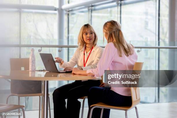 discussing coursework in the common area - intelligence stock pictures, royalty-free photos & images